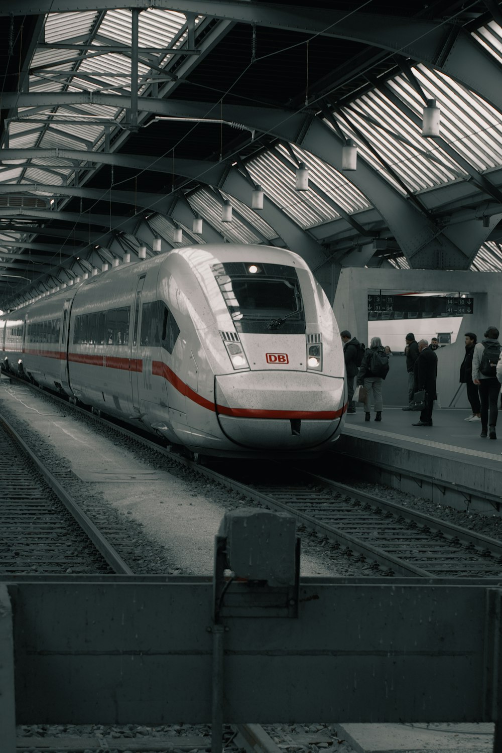 a white and red train pulling into a train station