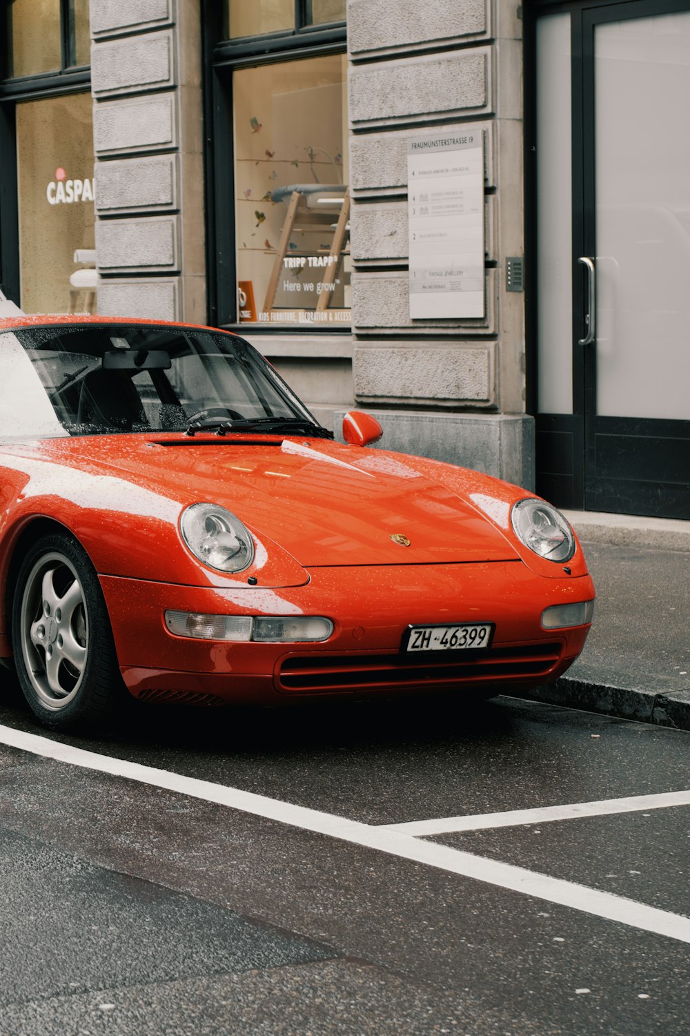 a red sports car parked on the side of the road