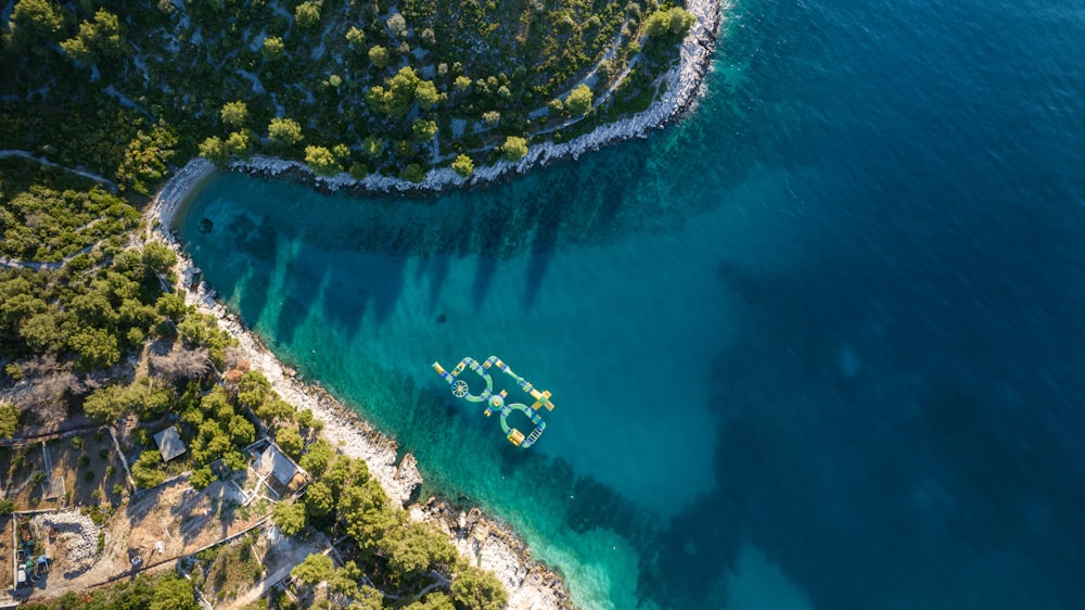 an aerial view of a boat on a body of water