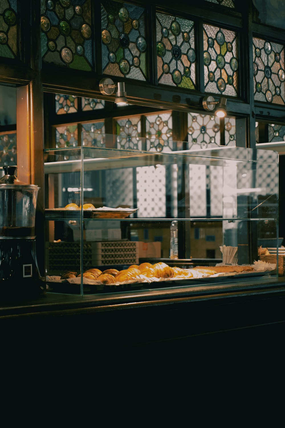 a bakery counter with a lot of pastries behind it