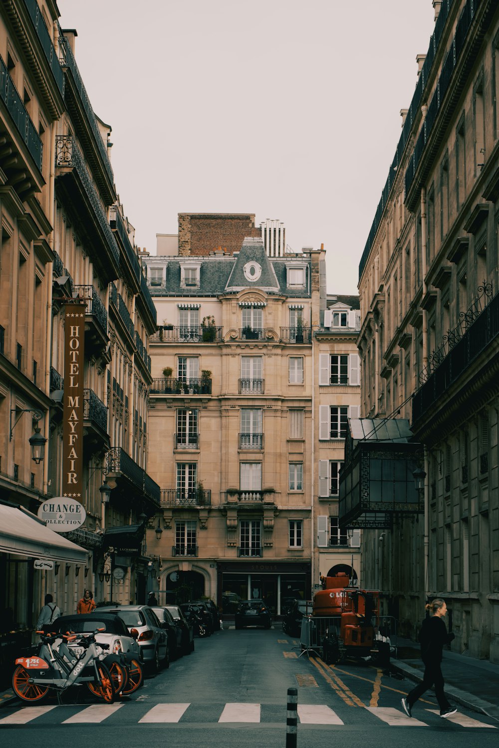 a narrow city street lined with tall buildings