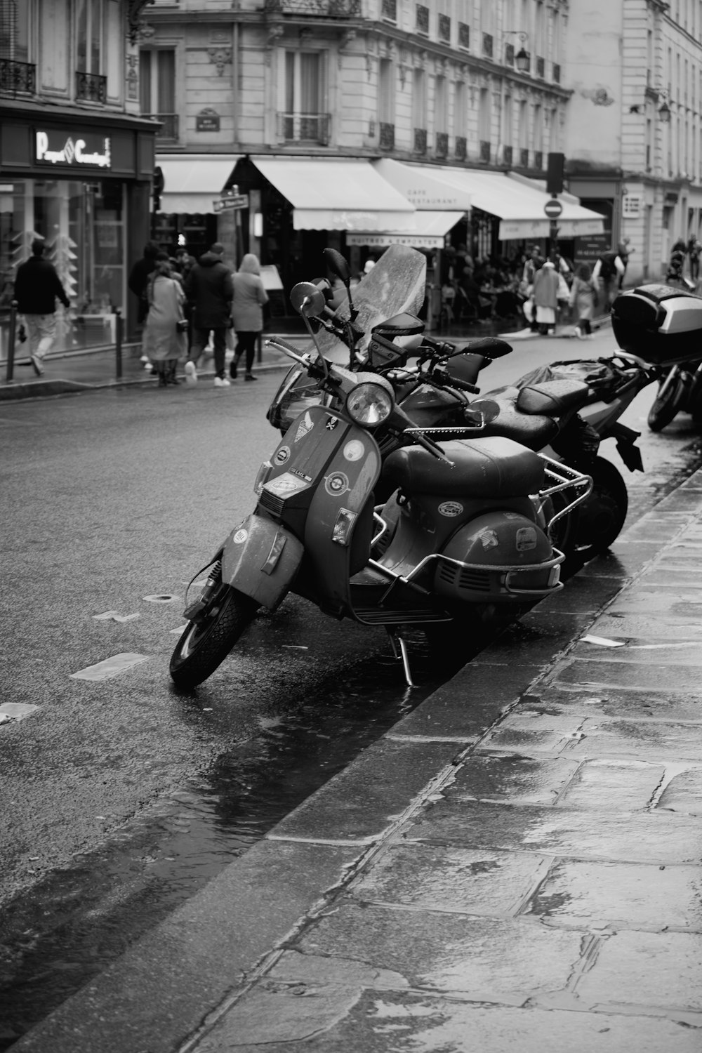 a row of motorcycles parked on the side of a street