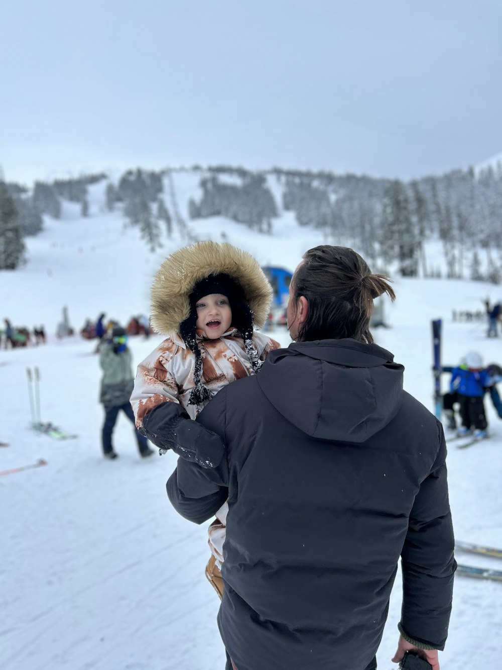 a woman in a fur hat standing in the snow