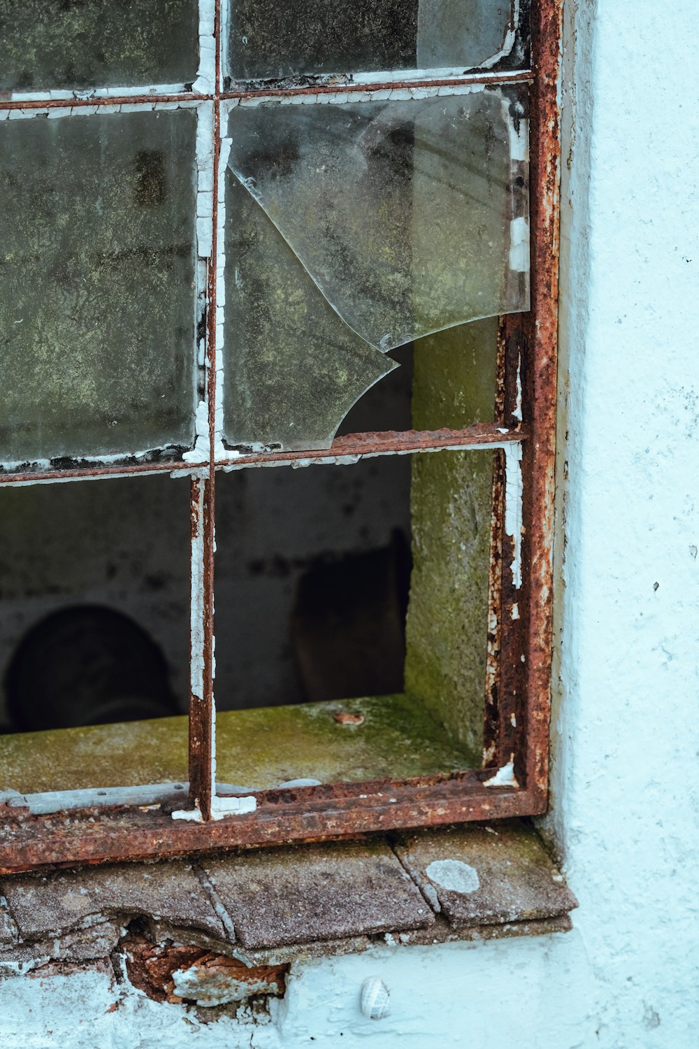 a broken window with a broken glass pane