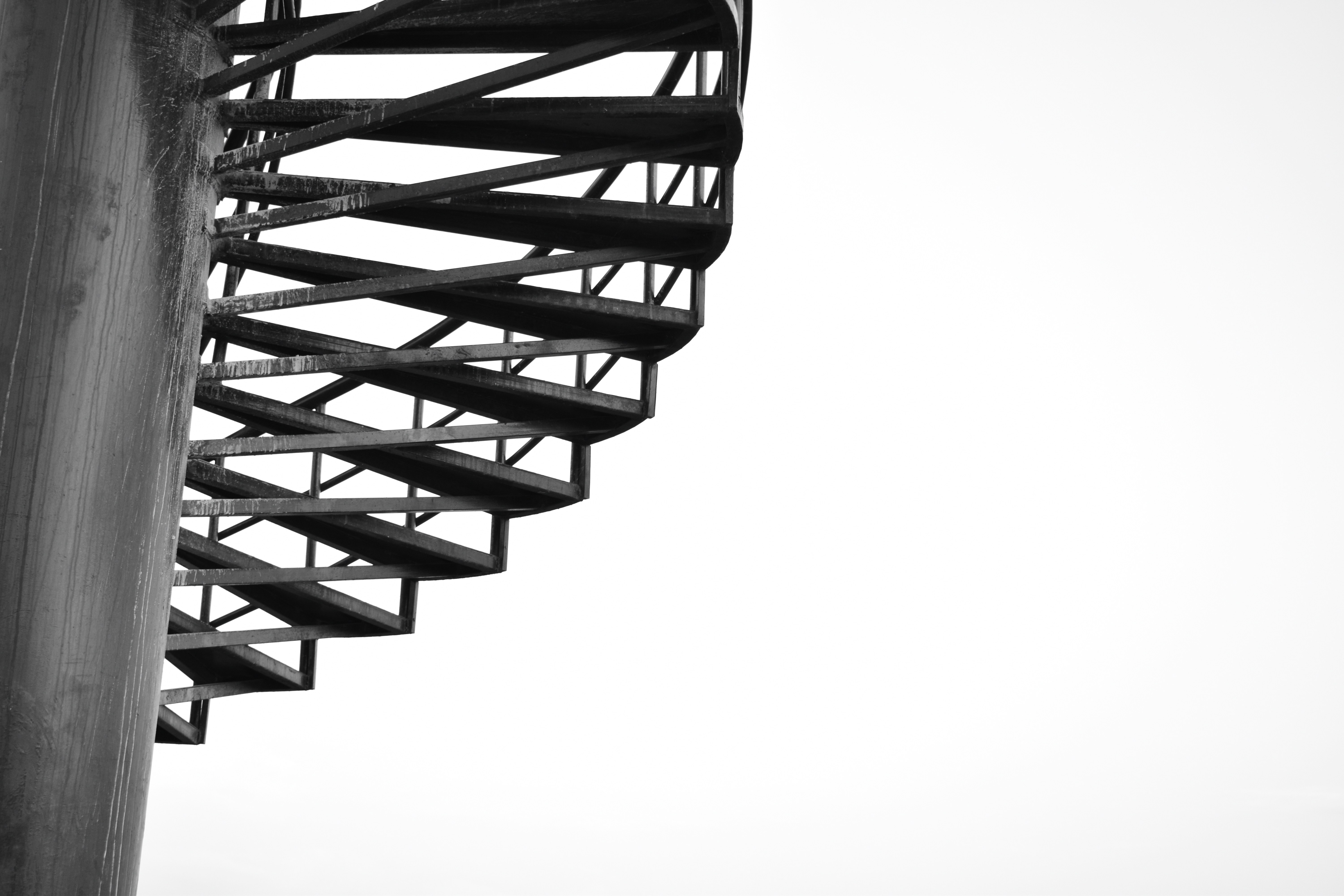 a black and white photo of a spiral staircase