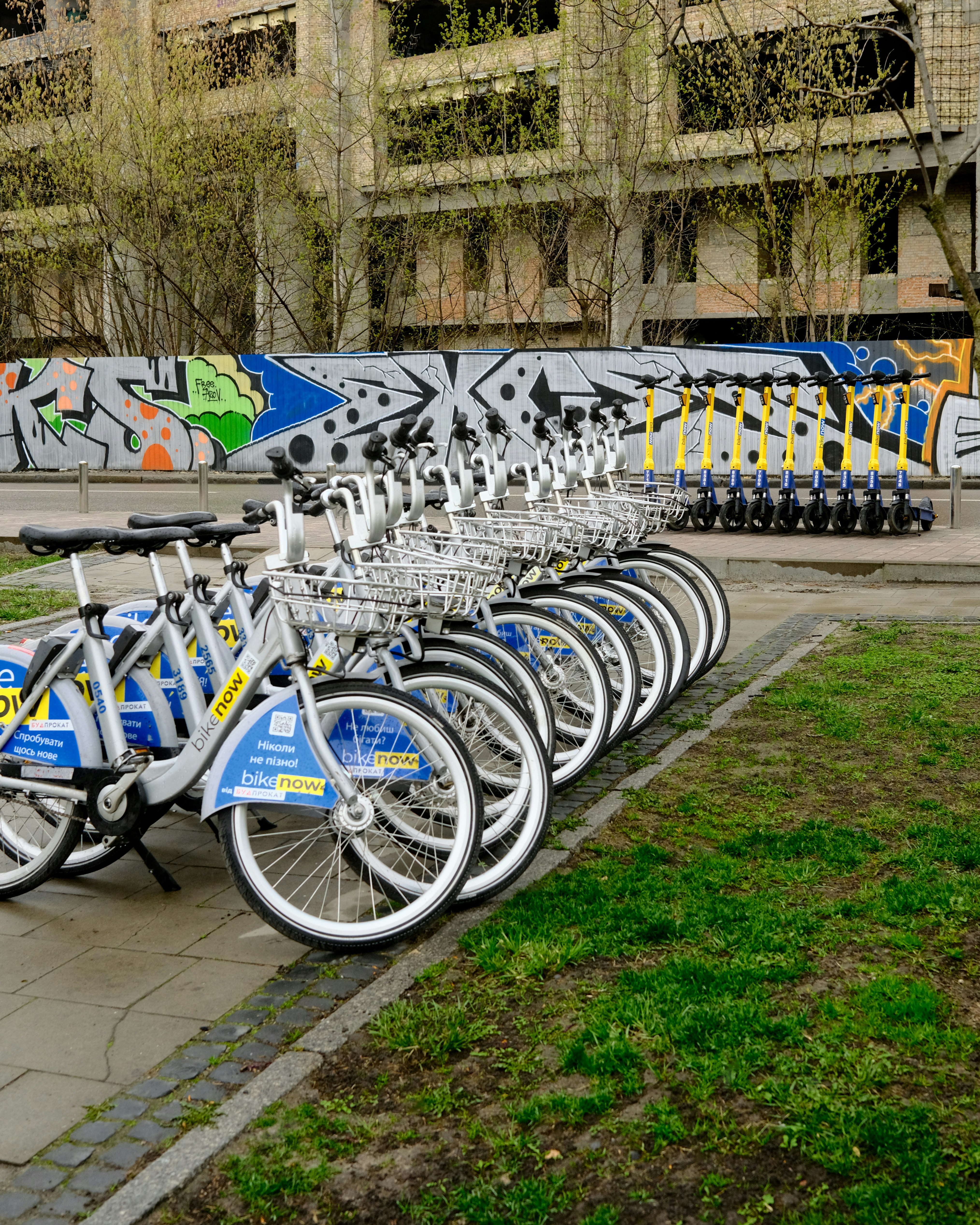 a row of bikes parked next to each other on a sidewalk