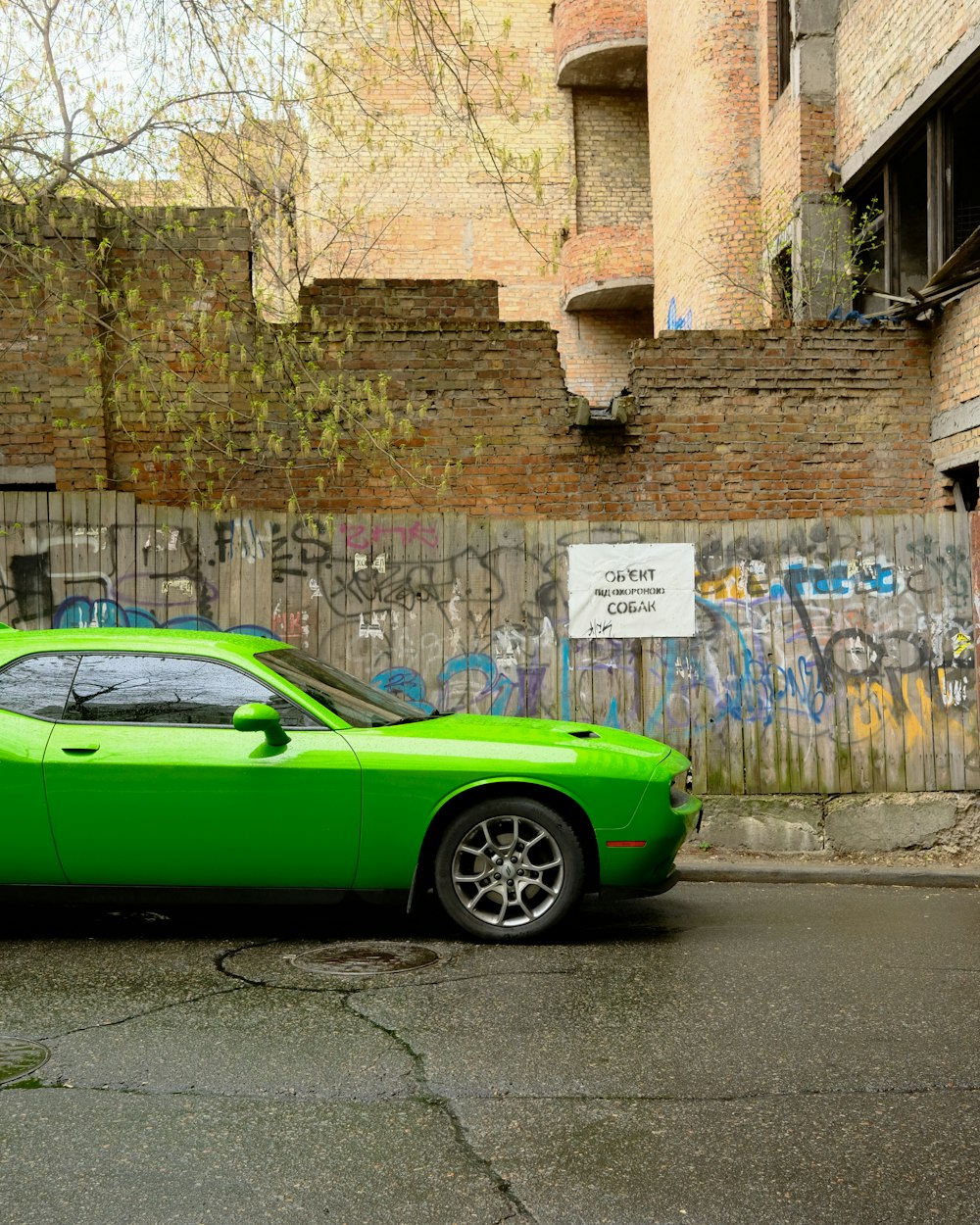 a green sports car parked on the side of the road