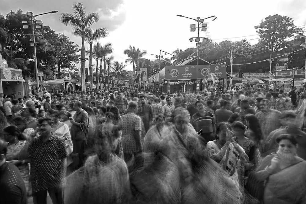 a large crowd of people walking down a street