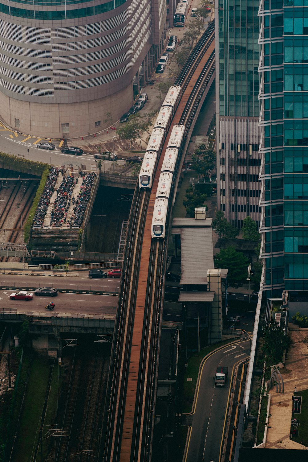 an aerial view of a train on the tracks in a city