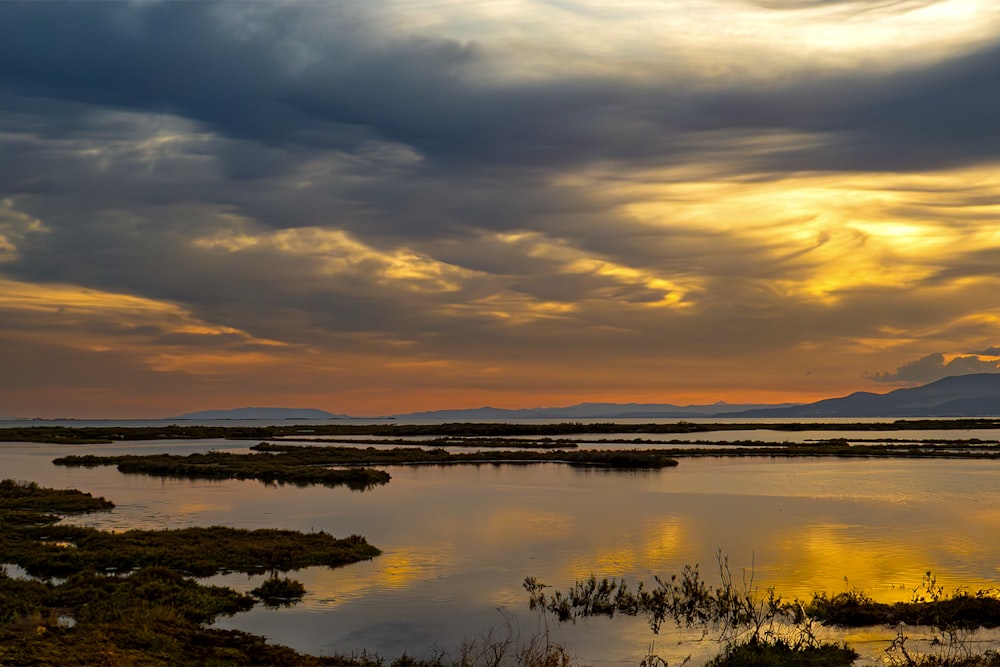 the sun is setting over a body of water