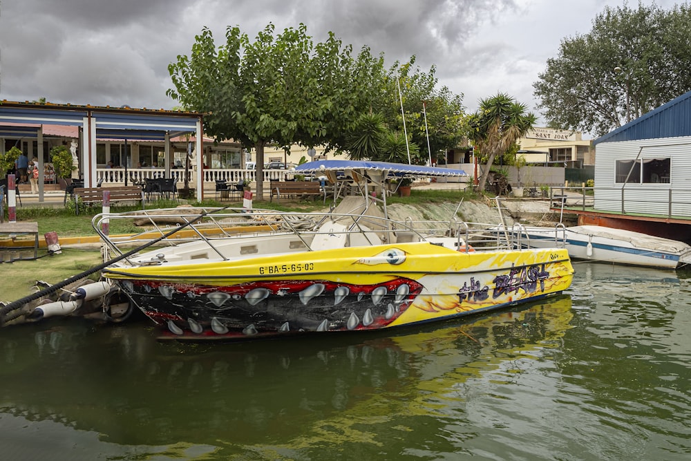 a yellow and white boat in a body of water