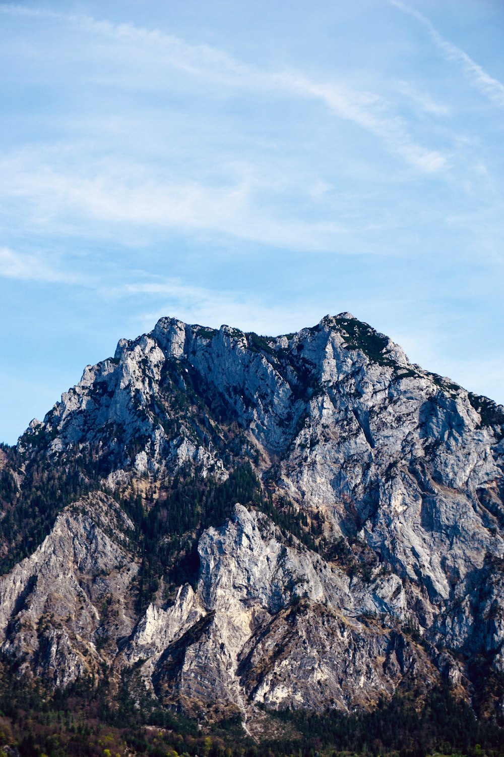 a mountain is shown with a blue sky in the background