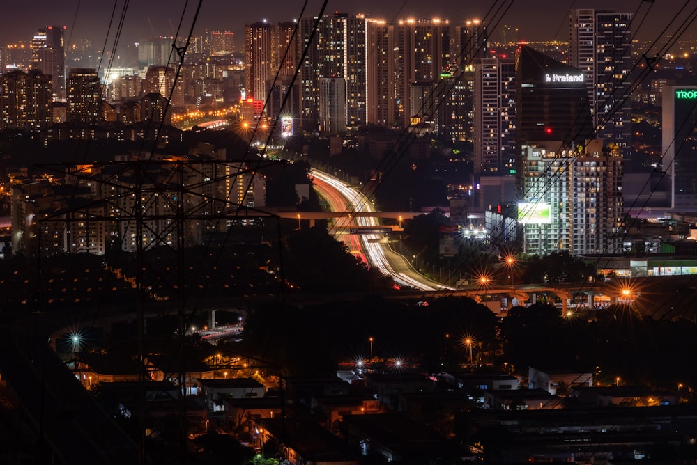 a view of a city at night from the top of a hill