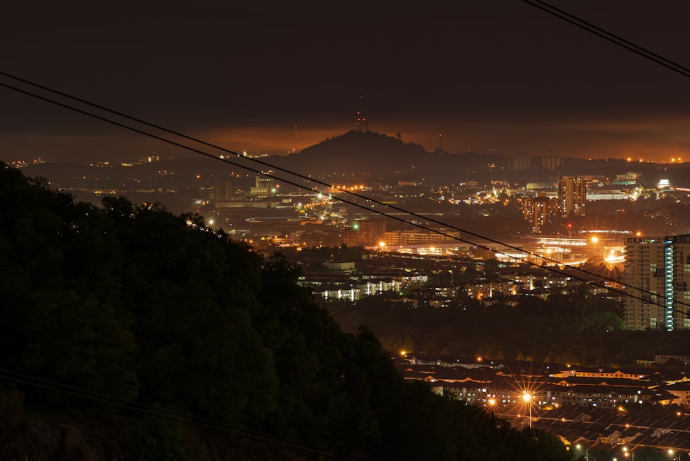 a view of a city at night from the top of a hill