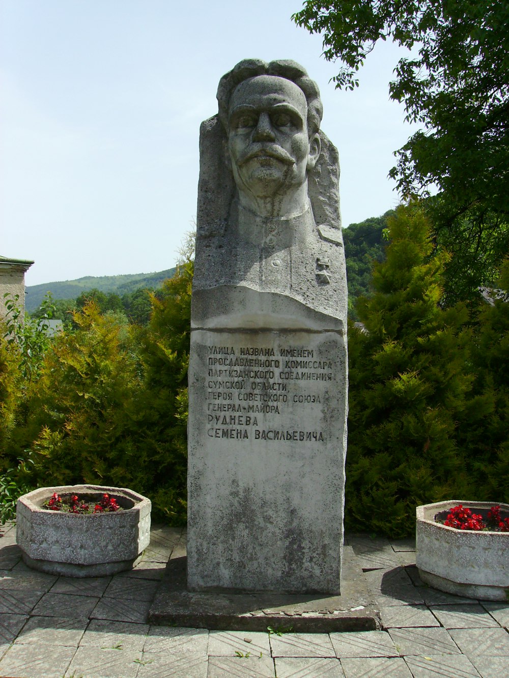 a statue of a man with a beard in a park