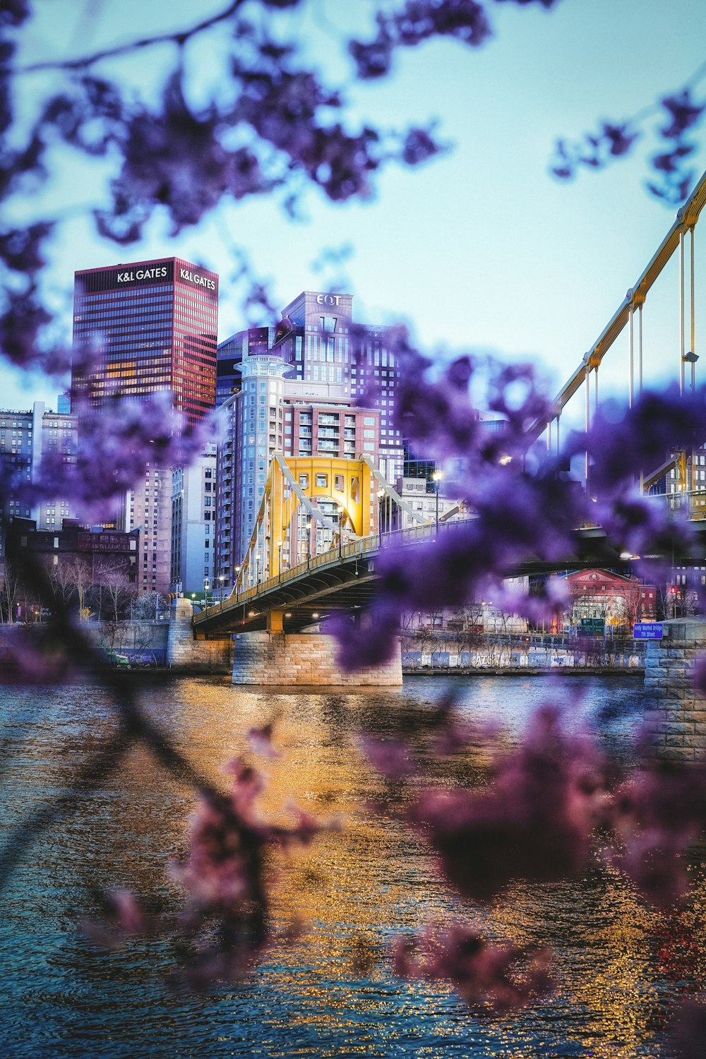 a bridge over a river with buildings in the background