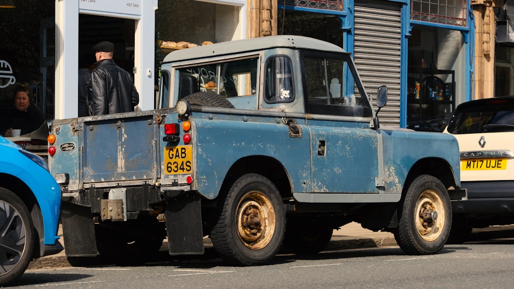 a blue truck parked on the side of the road