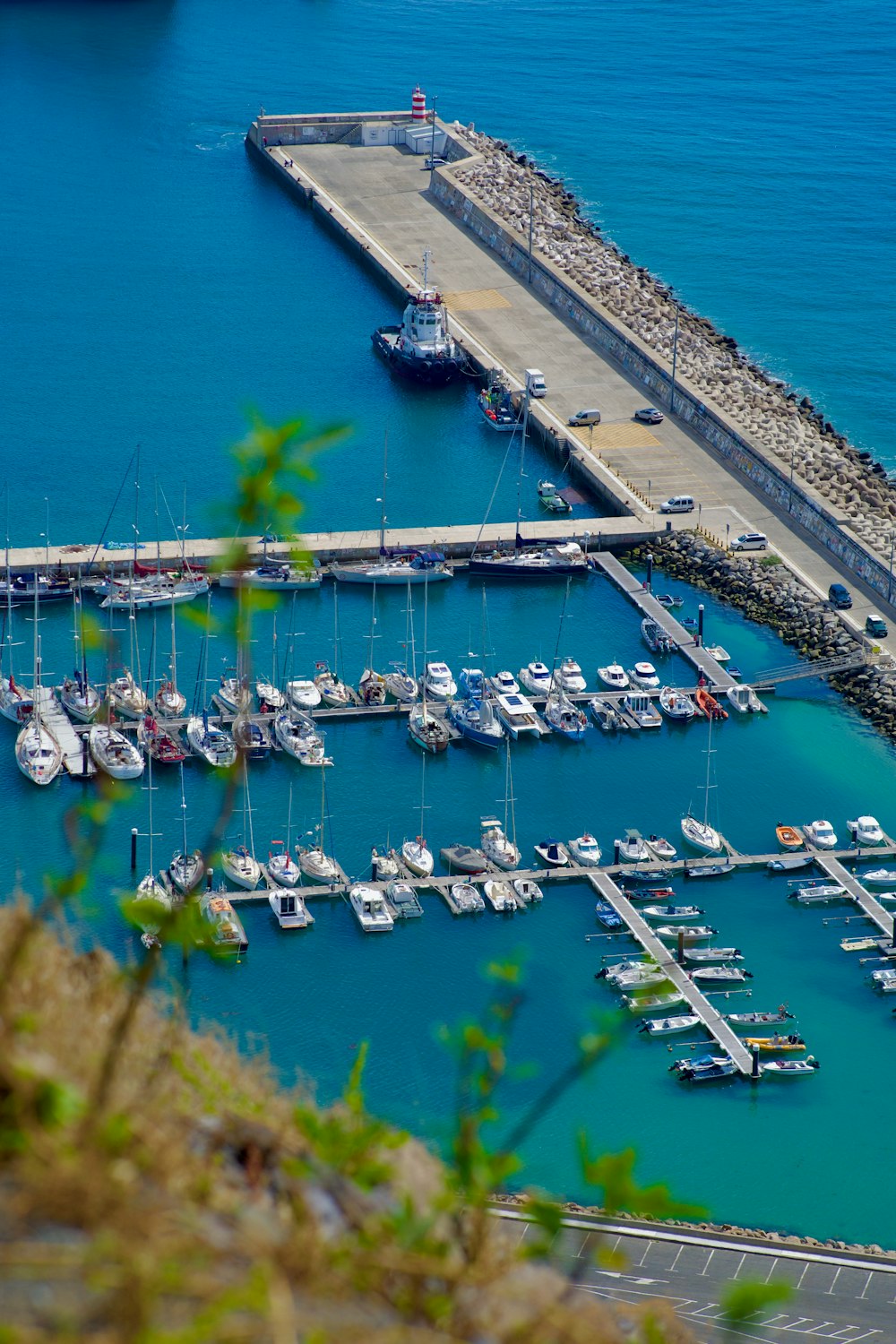 a harbor filled with lots of boats next to a pier