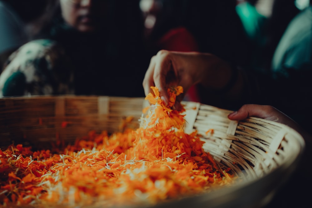 a basket filled with orange and yellow flowers