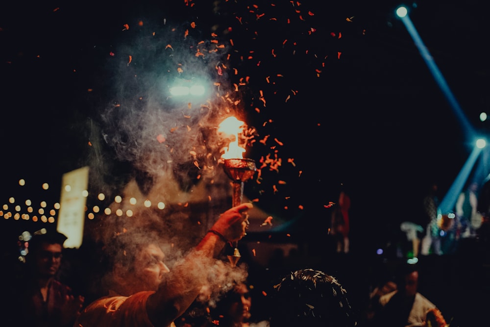 a group of people standing around a fire pit