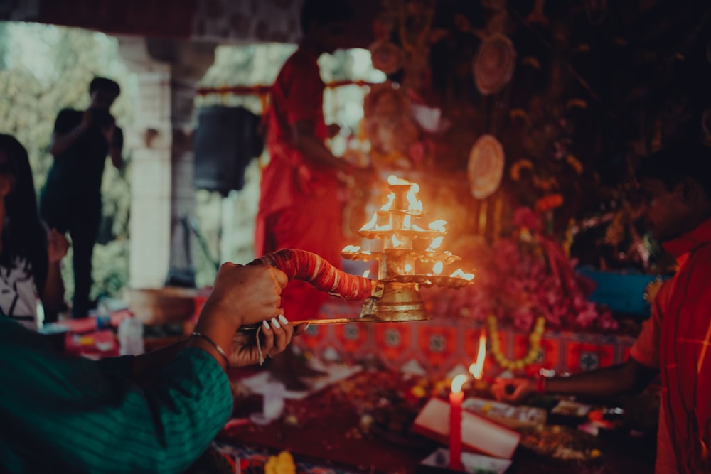 a person lighting a candle in a temple