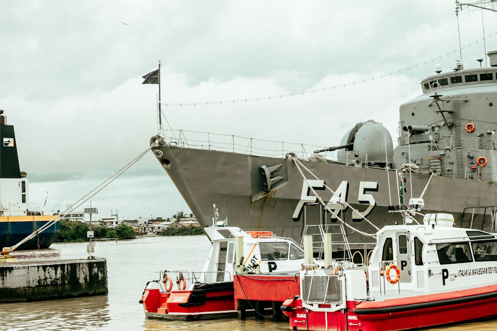 a large ship docked next to a smaller boat