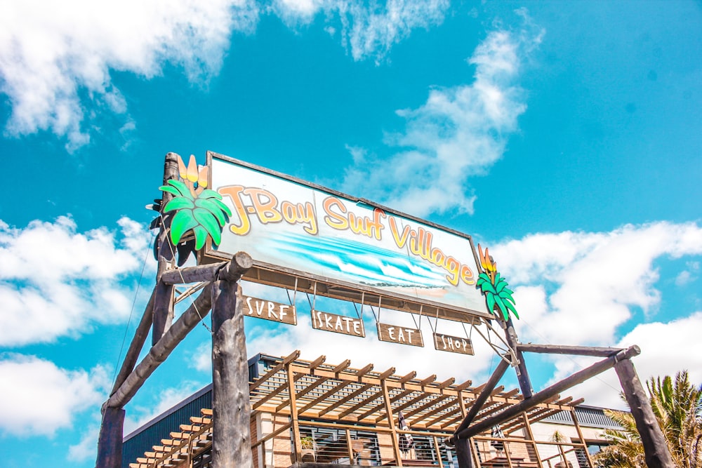 a sign for a tropical restaurant on a sunny day