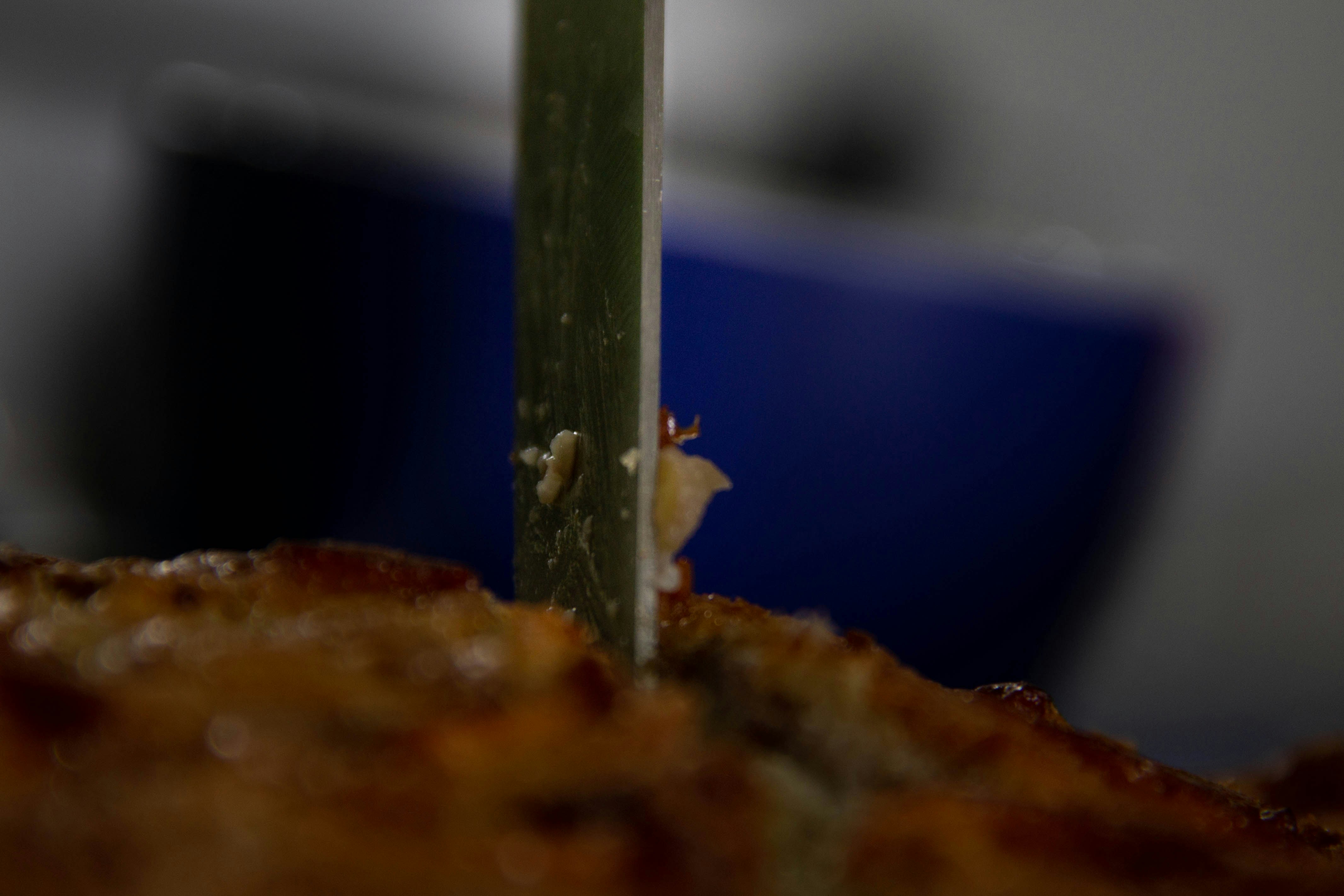 a close up of a green stick sticking out of a piece of food