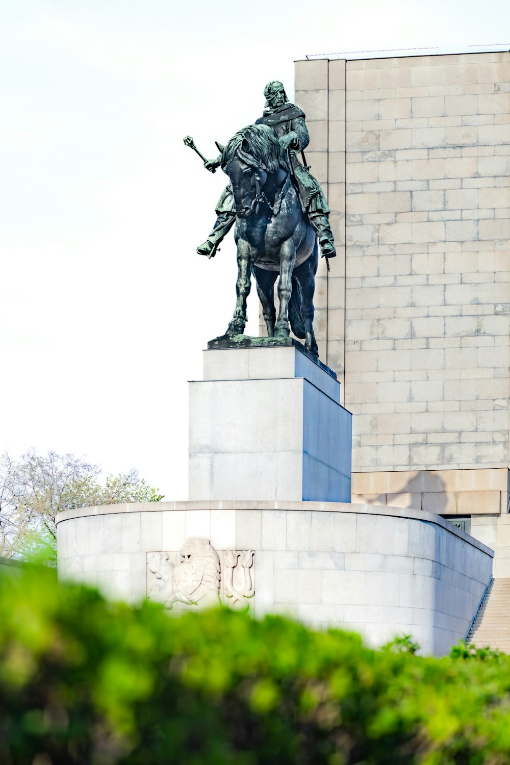 a statue of a man on a horse in front of a building