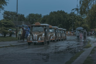 a line of buses parked on the side of a road