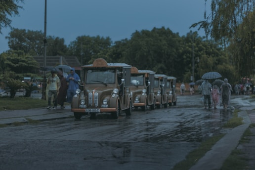 a line of buses parked on the side of a road