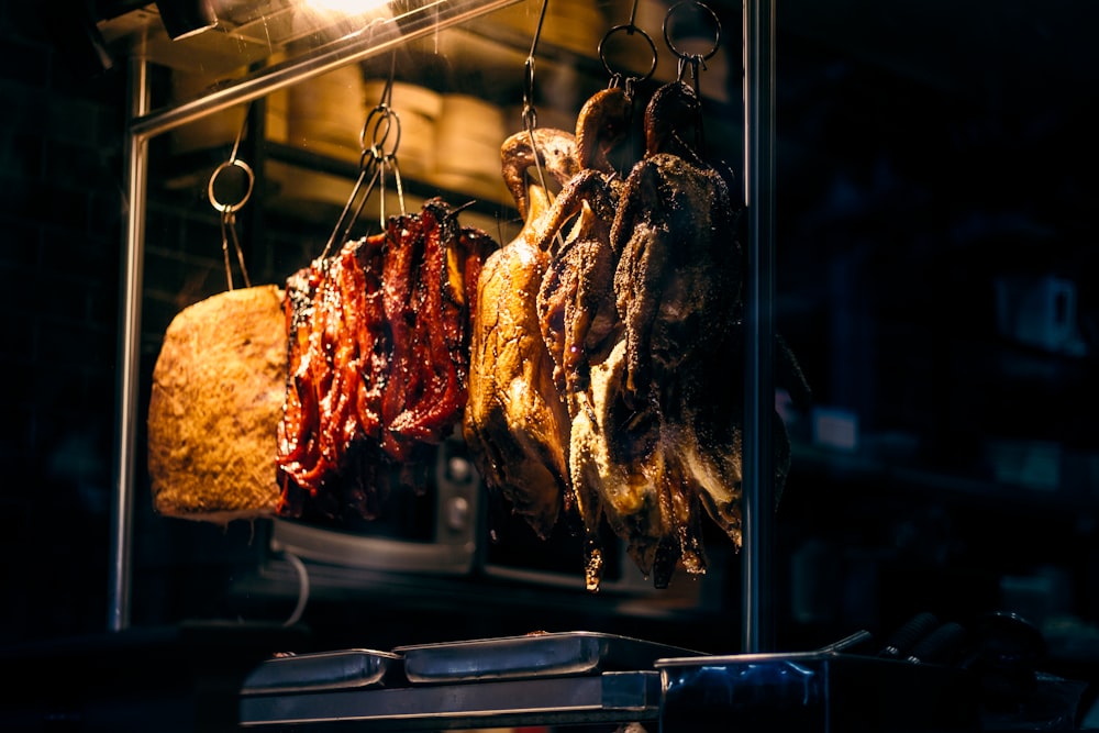 a bunch of meat hanging from a rack