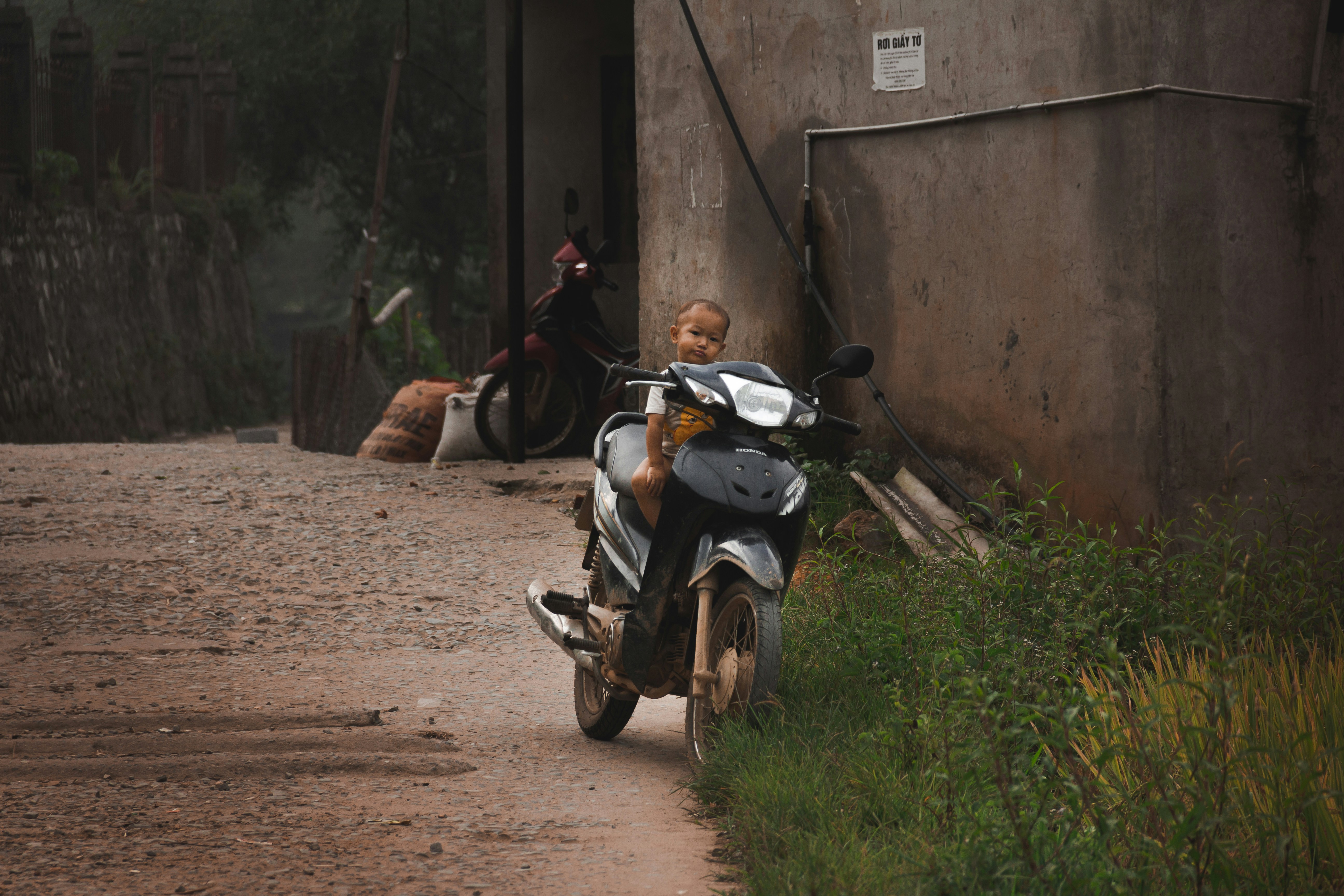 a small child is sitting on a motorcycle