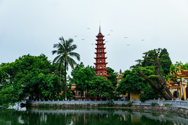 A tall tower sitting next to a body of water — Hanoi, Vietnam