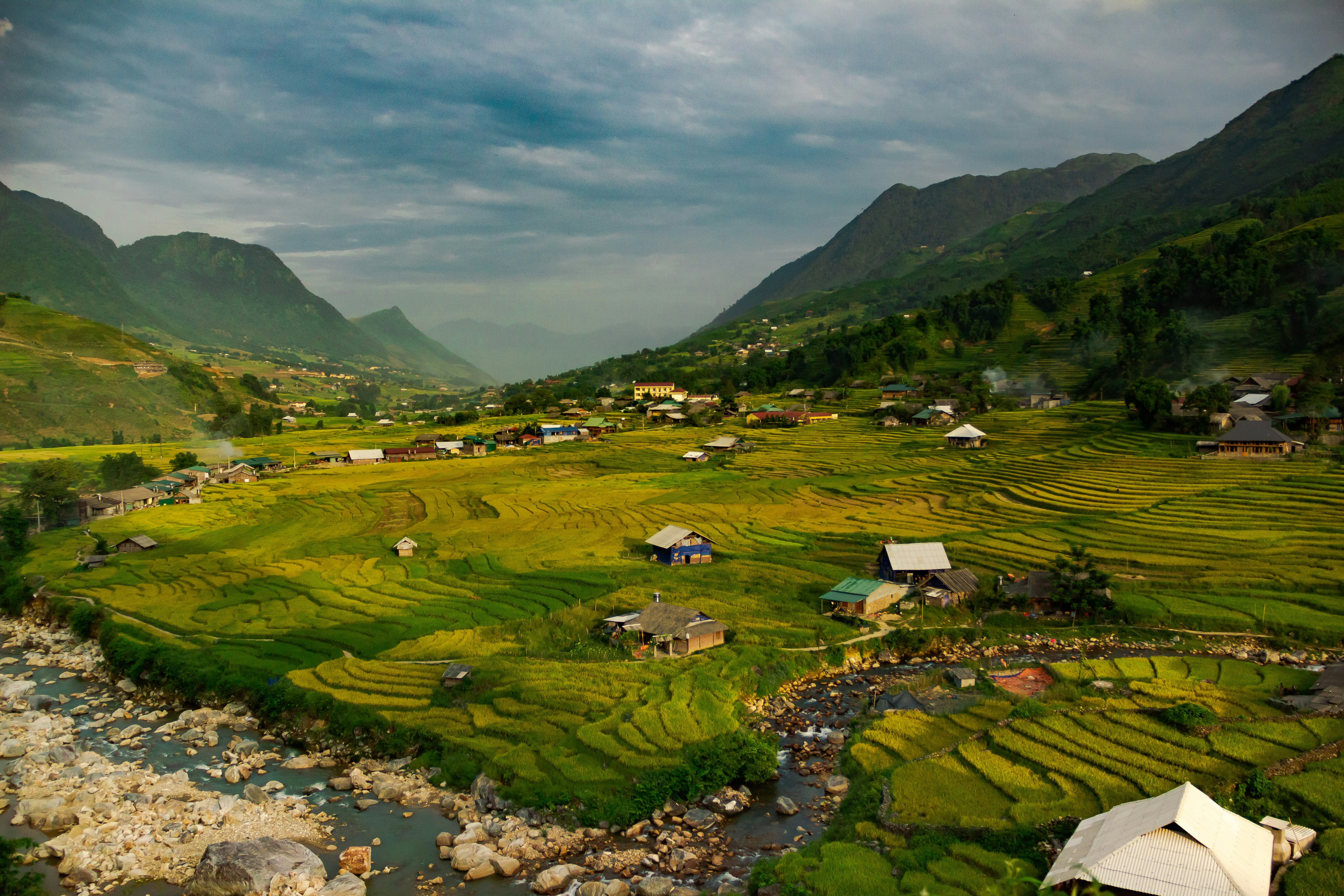 a river running through a lush green valley