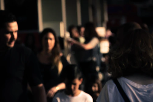 a group of people walking down a street next to each other