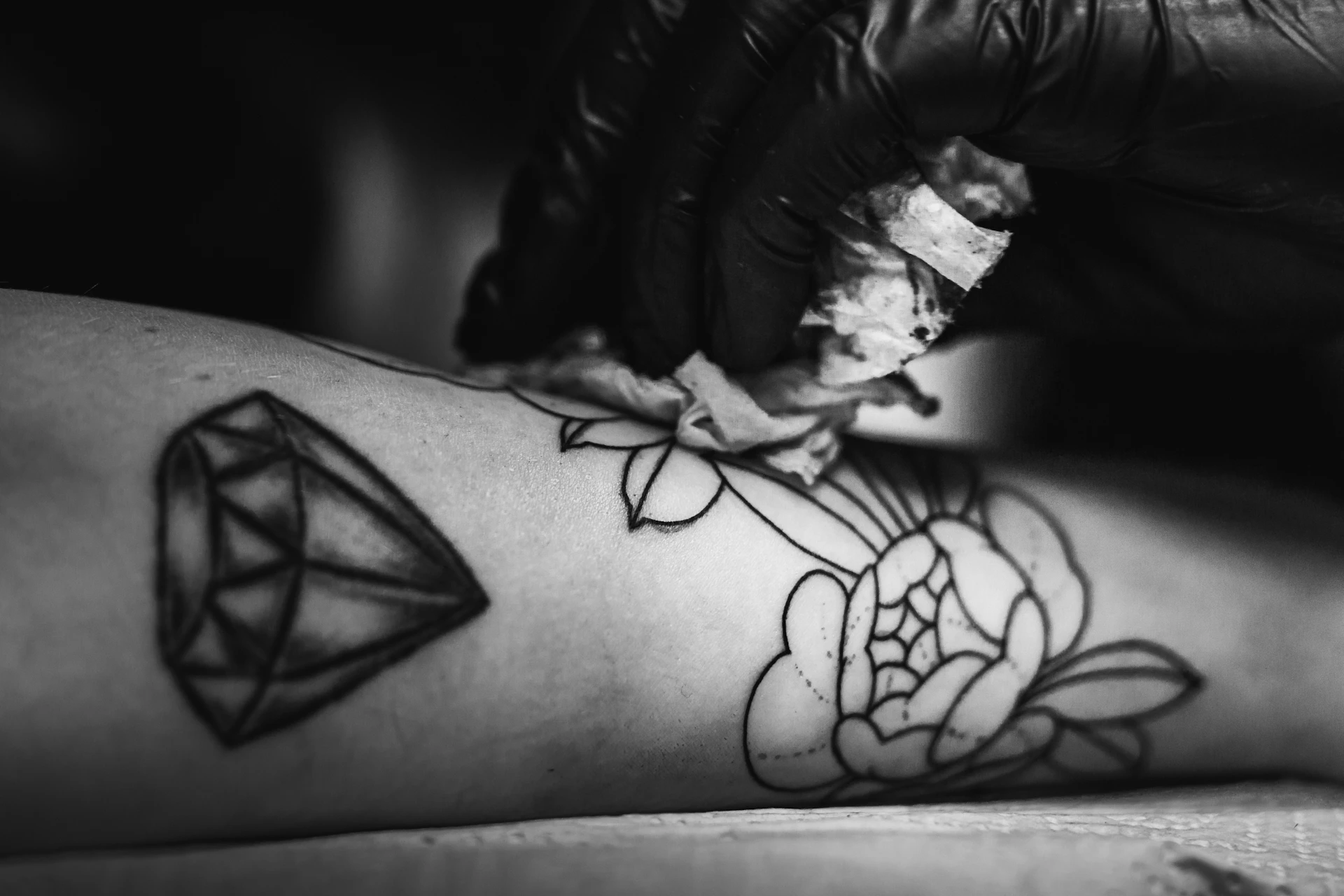 a person getting a tattoo done on their leg