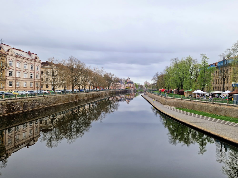 a river running through a city next to tall buildings