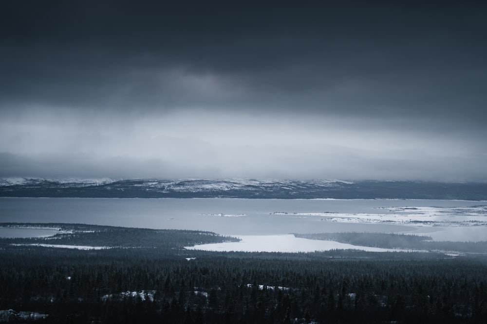 a large body of water surrounded by snow covered mountains