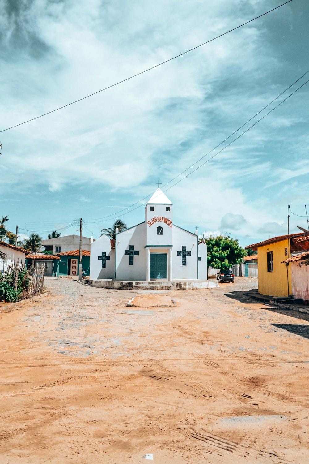 a white church with a cross on the top of it