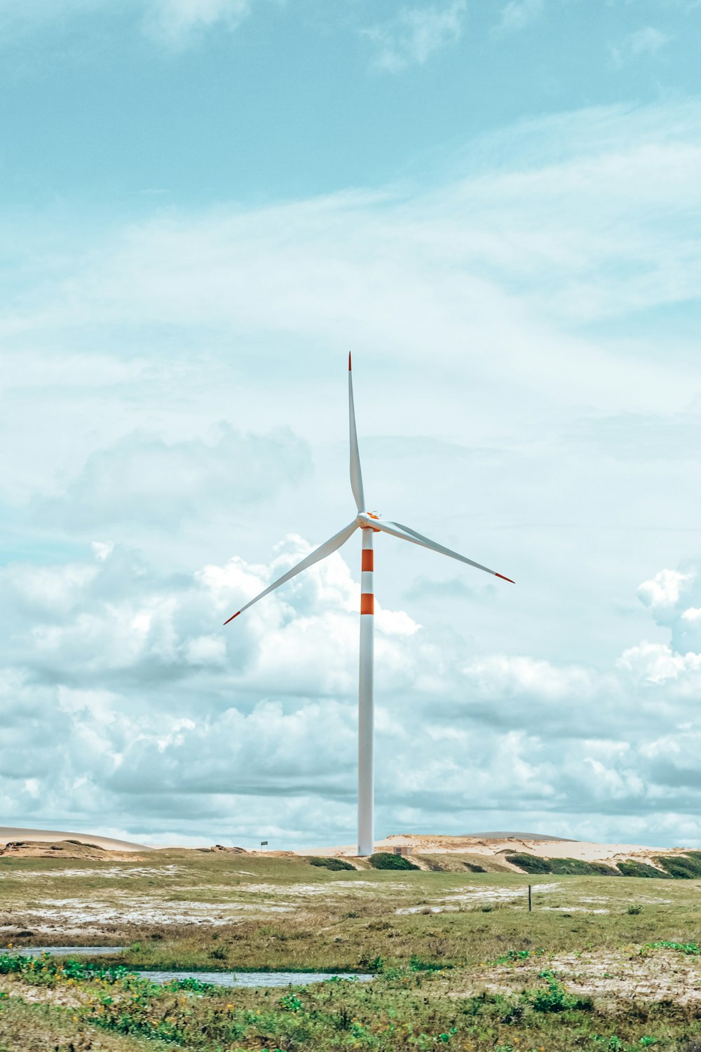 a wind turbine in the middle of a field