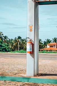 a gas pump sitting on the side of a road