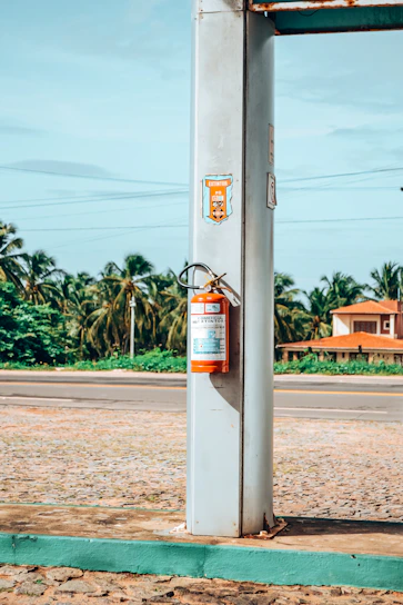 a gas pump sitting on the side of a road