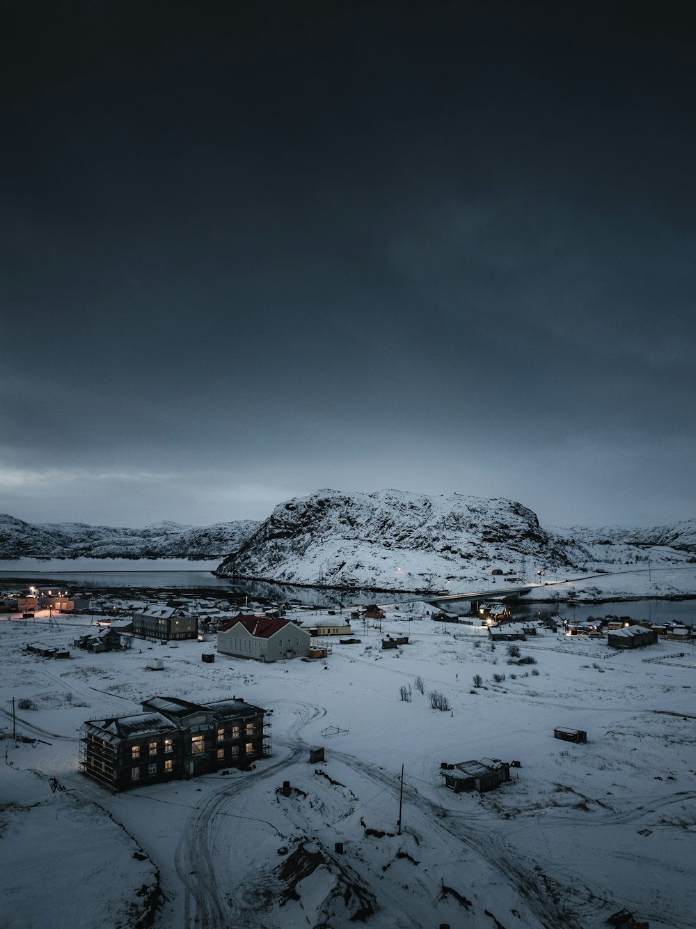 a snowy landscape with a mountain in the background