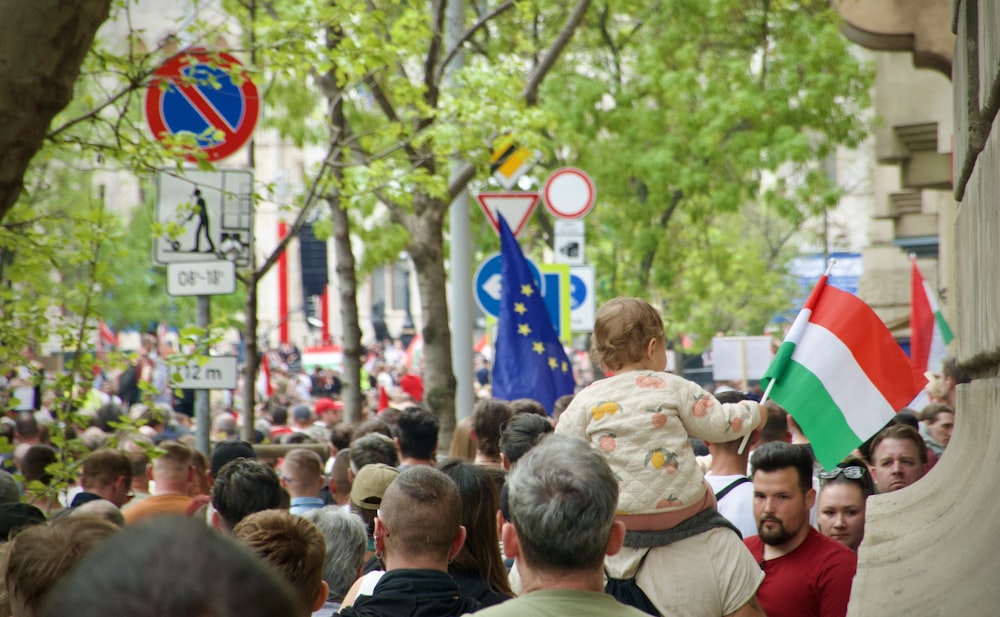 a crowd of people walking down a street