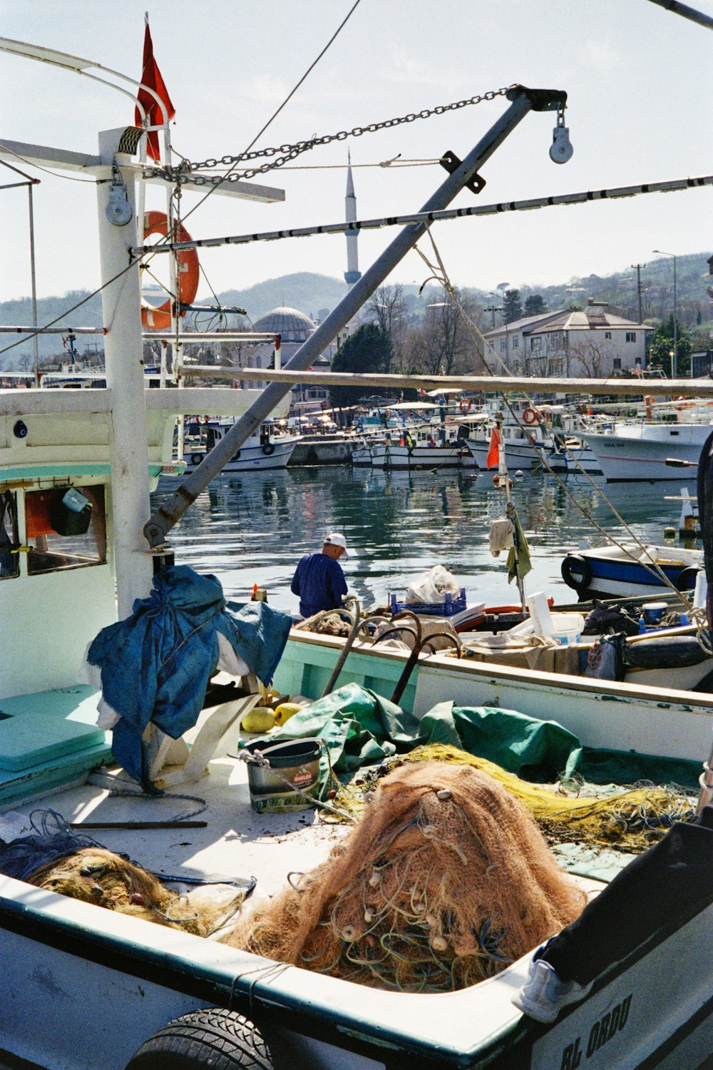 a boat is docked in a harbor with other boats