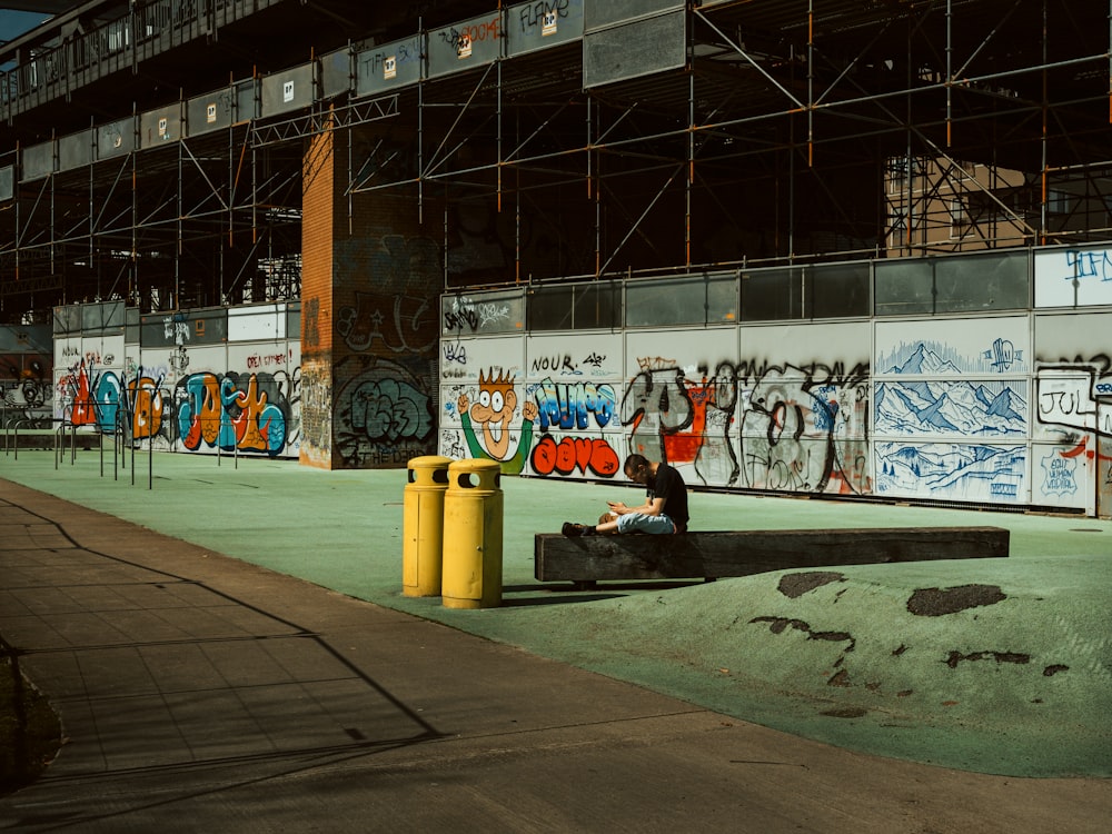 a person sitting on a bench in front of a building