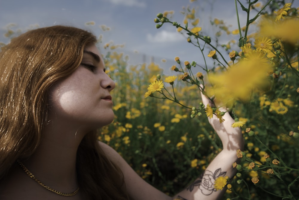 a woman in a field of yellow flowers