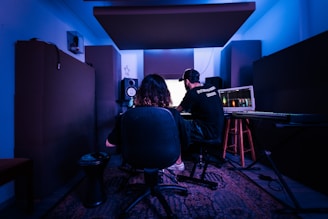 a man and a woman sitting in front of a computer