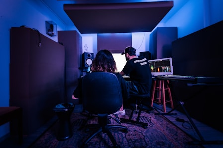 a man and a woman sitting in front of a computer